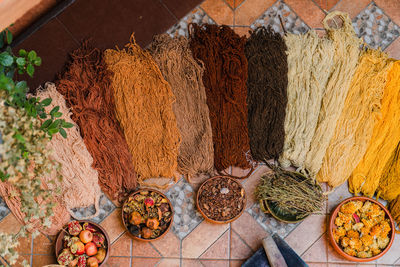 Handmade wool with natural dyes made of fruit displayed in bright earth colors in a textile factory.