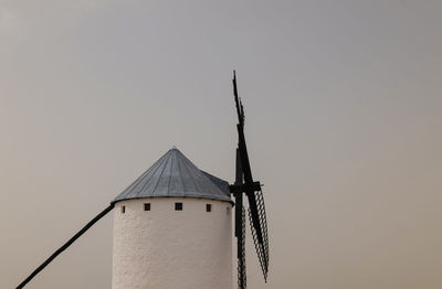 Low angle view of spanish traditional white windmill against clear sky