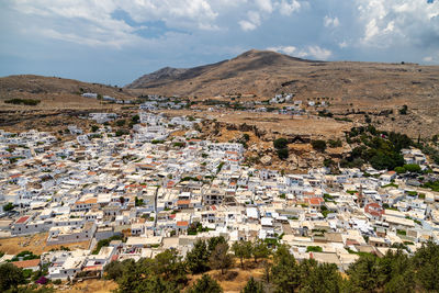 View at the city of lindos on greek island rhodes with white houses and mountain in the background