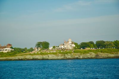 View of building by sea against sky