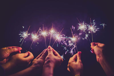 Low angle view of firework display at night