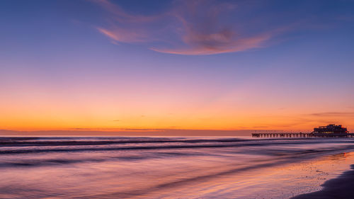 Scenic view of sea against romantic sky at sunset