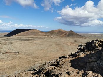 Scenic view of arid landscape against sky