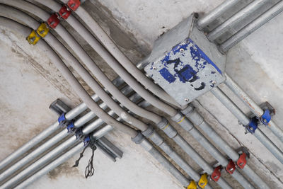 High angle view of pipes on floor against wall