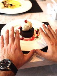 Midsection of person holding ice cream in plate