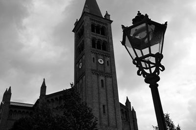 Low angle view of bell tower against cloudy sky