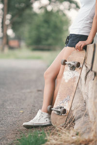 Low section of woman with skateboard