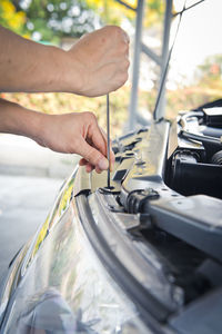 Auto mechanic checking car engine,worker selective focus