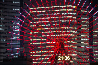 Low angle view of illuminated ferris wheel at night