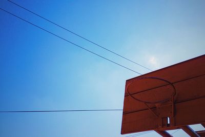 Low angle view of cables against blue sky