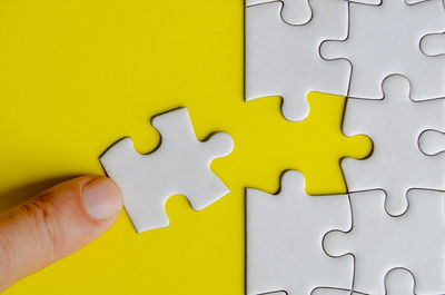 Cropped hand holding jigsaw piece