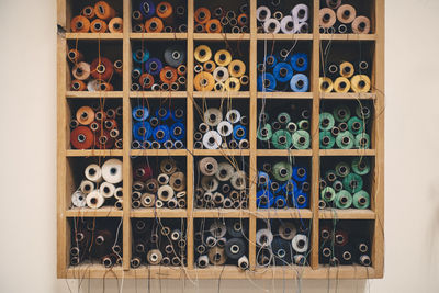 View of spools in shelf on wall