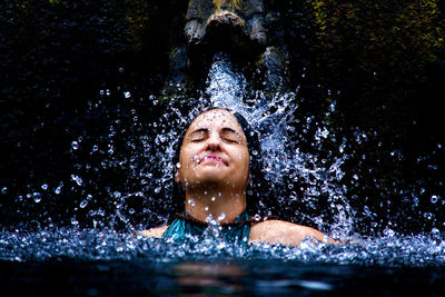 Portrait of a smiling woman swimming in pool