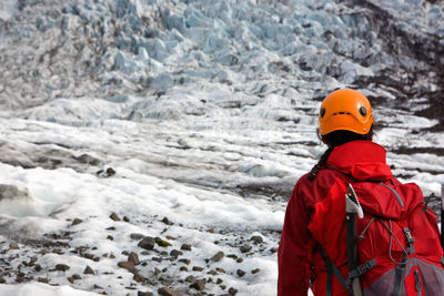 Woman hiking up sólheimajökull glacier in south iceland