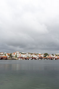 Scenic view of sea by townscape against sky in sweden