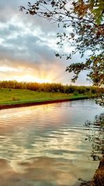 Scenic view of lake against sky at sunset