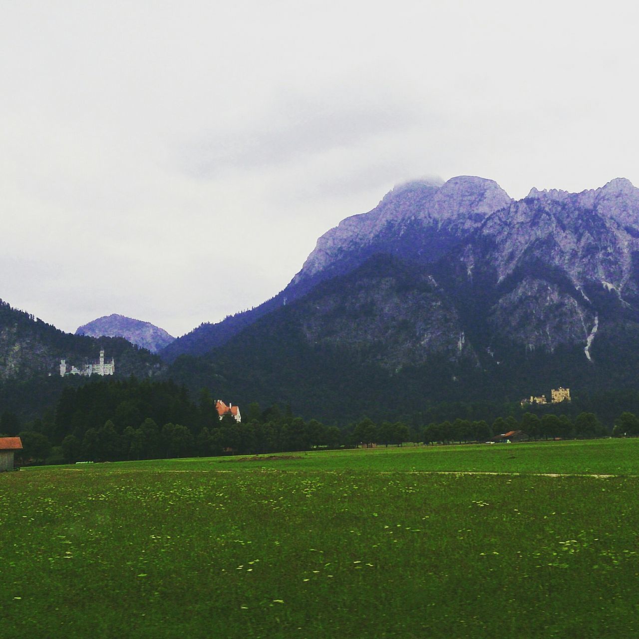 mountain, grass, mountain range, landscape, tranquil scene, tranquility, grassy, field, scenics, beauty in nature, green color, sky, nature, non-urban scene, building exterior, house, built structure, idyllic, outdoors, day