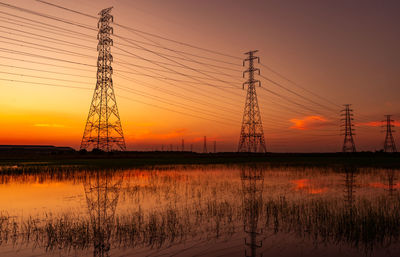 High voltage electric pylon and electrical wire with sunset sky. electricity poles. power and energy