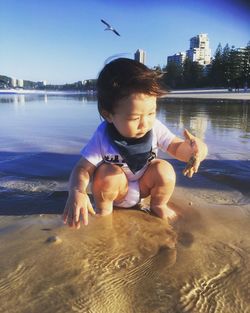 Boy looking at sea shore