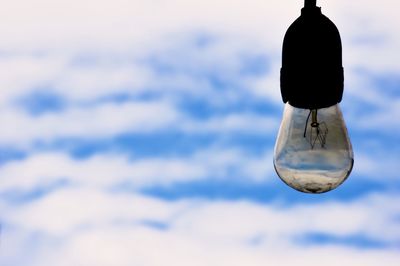 Low angle view of light bulb against sky