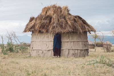 Scenic view of hut on a field against sky