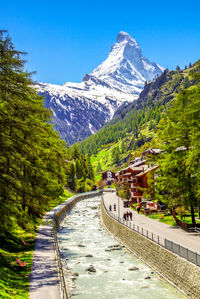 Scenic view of river by mountains