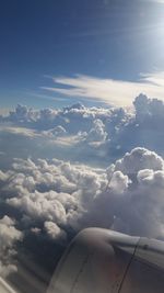 Aerial view of cloudscape over airplane wing