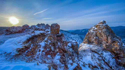 Scenic view of snow covered mountains against sky during sunset