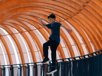 Low angle view of man standing against sky