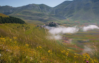 Panoramic view of castelluccio di norcia with fog at early morning in umbria, italy, europe