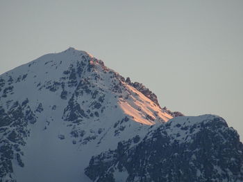 Scenic view of snowcapped mountains against clear sky