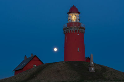 Low angle view of lighthouse against clear blue sky