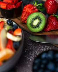 High angle view of chopped fresh fruits in bowl on table