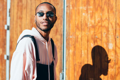 Portrait of young man wearing sunglasses standing outdoors