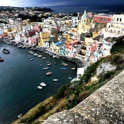 High angle view of cityscape by sea against sky