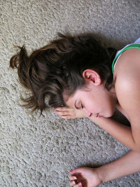 High angle view of woman sleeping on wall