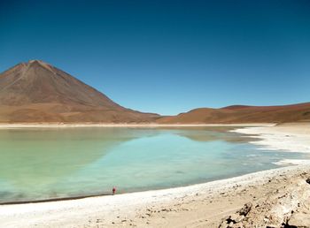 Full length of woman sanding by lake in desert
