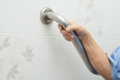 Midsection of man working in bathroom