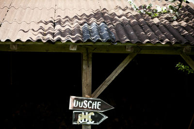 Low angle view of information sign on roof of building