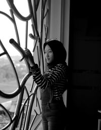 Teenage girl looking through window