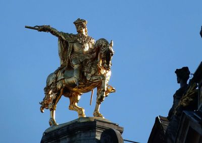 Low angle view of statue against clear blue sky