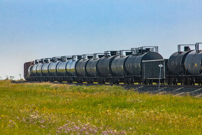 Train on field against clear sky