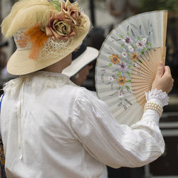 Close-up of woman holding white flowers