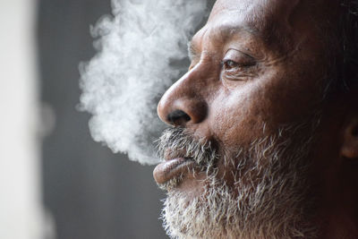 Close-up of man smoking cigarette