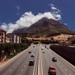 Cars on road against mountain range