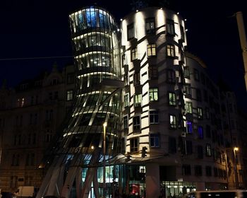 Low angle view of illuminated building against sky at night