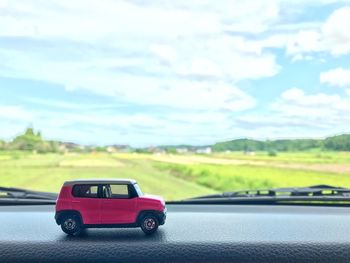 Toy car on road against sky