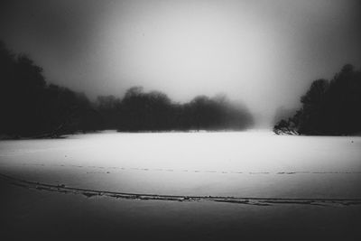 Scenic view of field against sky during winter