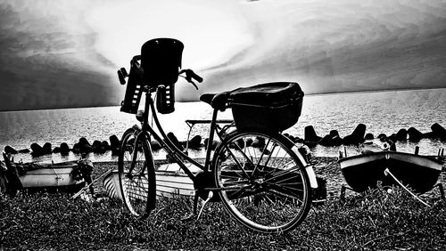 Bicycle parked on field against sky