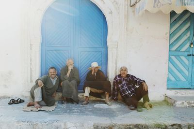 People sitting in front of building